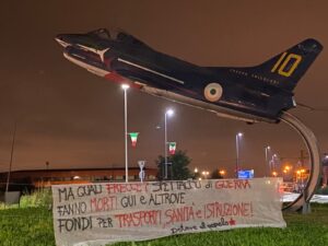 Striscione antimilitarista sulla freccia tricolore monumento a Caselle: azione rivendicata da Potere al Popolo